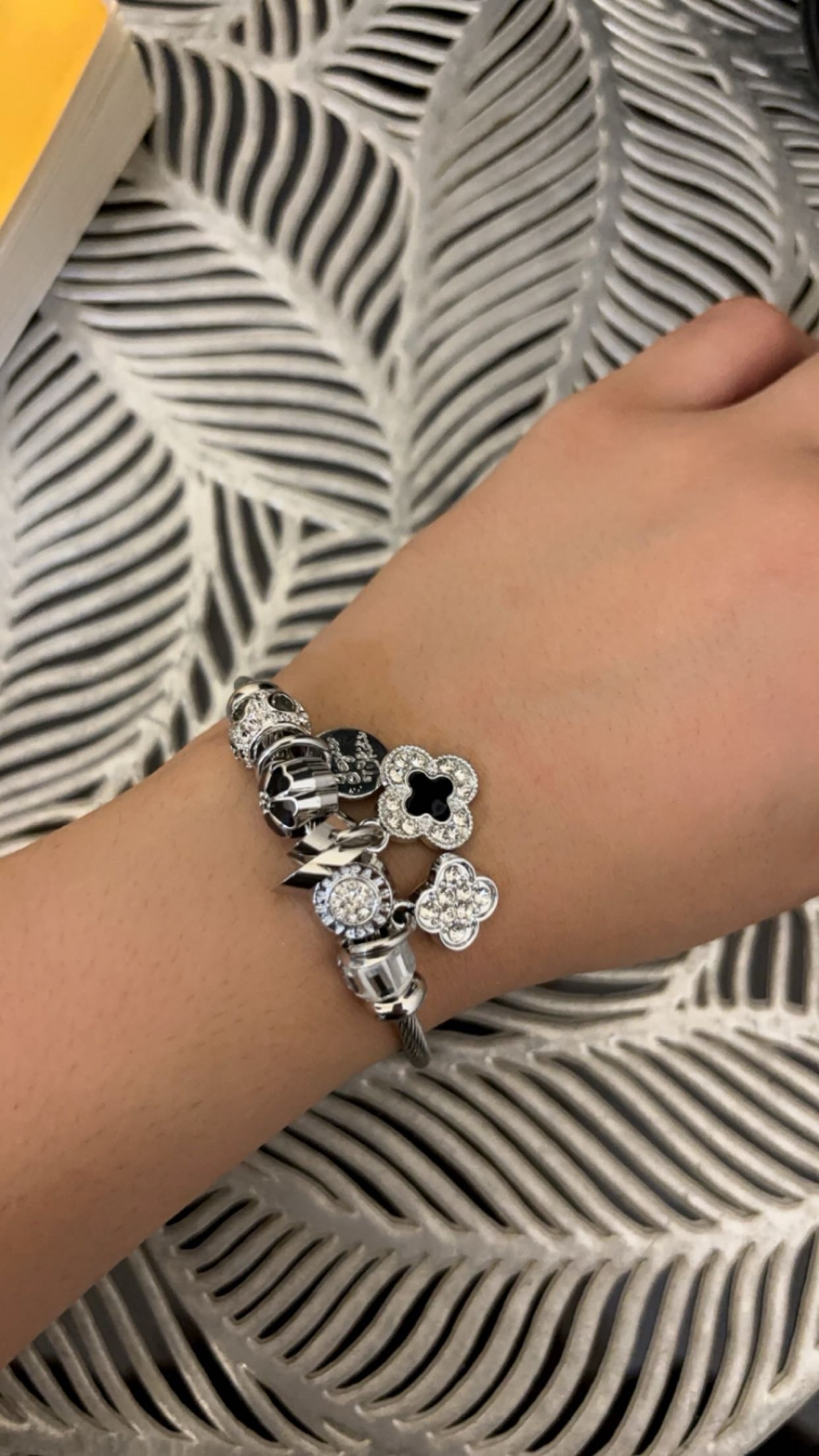 https://blingupp.com/products/white-black-flower-charm-bracelet