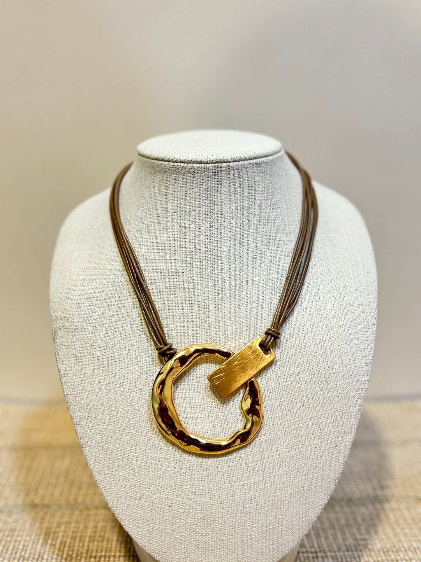 https://blingupp.com/products/brown-leather-golden-necklace